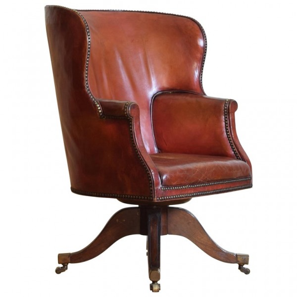 Mahogany and Leather Upholstered Swivel Wing Chair