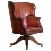 Mahogany and Leather Upholstered Swivel Wing Chair